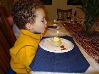 DSC00566  Birthday celebration:  Since the visit was in between the boys' birthdays, we had one big celebration.  Aidan blows out the candle on his cupcake. : From MobileMe